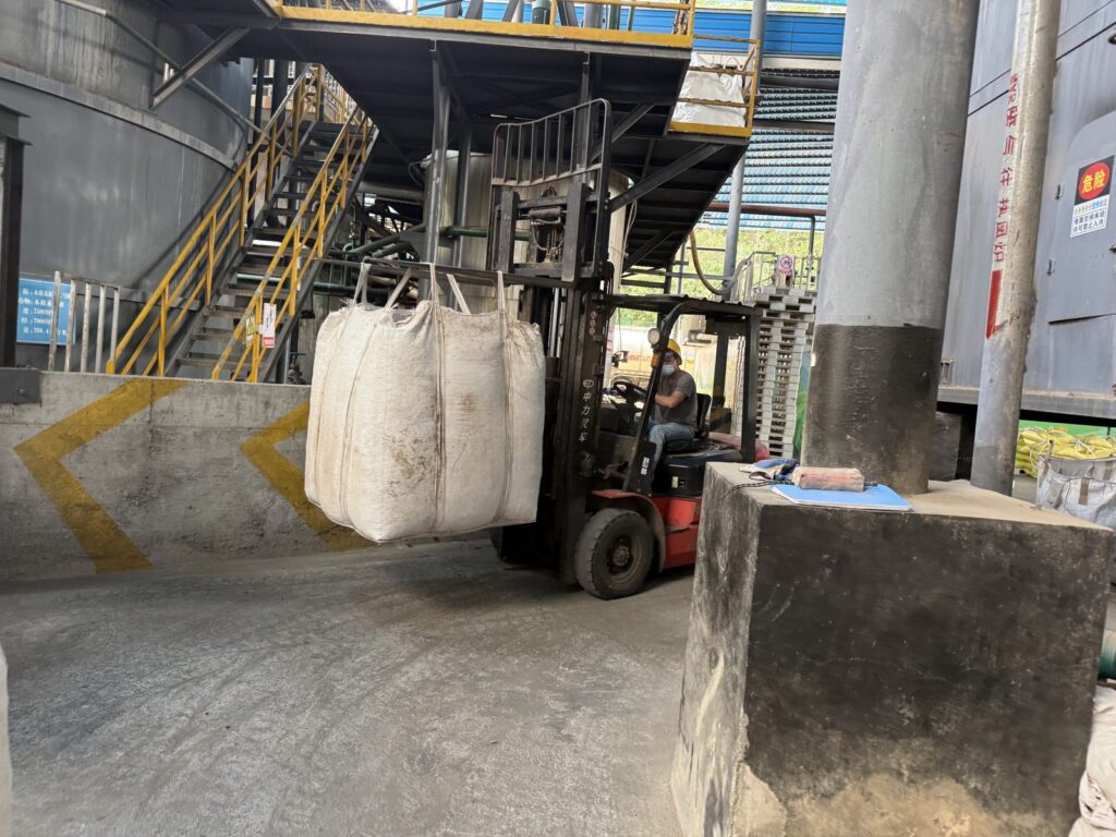 Jumbo bag of lignosulfonate powder handled by forklift